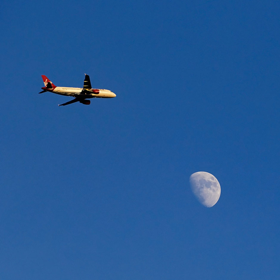 plane flies near moon